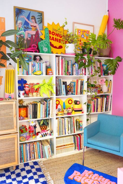 The colourful studio of Kitiya Palaskas, craft-based designer, filled with eclectic decor, a blue armchair, pink feature wall, and blue and white checkered rug. Home Office Colourful, Colorful Home Ideas, Bright Office Ideas, Dopamine Office, Colourful Houses Interior, Funky Office Decor, Bright Office Design, Fabric Wallhangings, Small Room Wall Decor