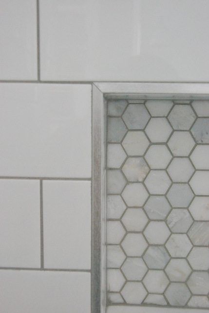 Choosing our shower tile design with subway tile and marble tile niche. This white and gray bathroom features IKEA vanities and herringbone floor. Tile Niche, Bathroom Niche, Subway Tile Showers, Bathroom Features, Apartment Decoration, Gray Bathroom, Tub Surround, Herringbone Floor, Shower Niche