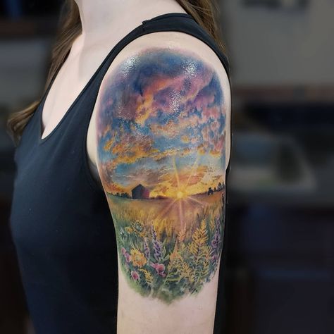 In colour realism, @katarina.heinze was able to capture this piece of Saskatchewan, the "Land of Living Skies," in a tattoo on the arm! There's a lot of detail! The fluffy clouds, the flowers, the sunlight, farm houses and crops! It's such a wonder how artist's can capture light in a picture by using warm colours and using cool colours to contrast. Prairie Tattoo Landscape, Saskatchewan Tattoo Ideas, Western Scenery Tattoo, Field Tattoo Nature, Colored Nature Tattoo, Farm Scene Tattoo, Field Of Wildflowers Tattoo, Farm Tattoo Sleeve, Saskatchewan Tattoo