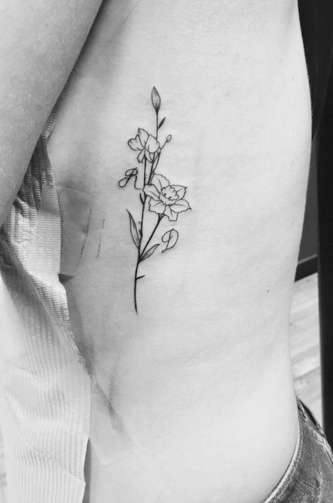 Narcissus & Sweet pea flower tattoo birth flowers #narcissus #sweet pea #flower #tattoo #minimalist #ink #initials #ribtattoo Dainty December Flower Tattoo, Narcissus And Sweet Pea Flower Tattoo, Narcissus Tattoo December, Sweet Pea And Narcissus Tattoo, Sweet Pea And Daffodil Tattoo, Daffodil And Sweet Pea Tattoo, Minimalist Narcissus Tattoo, Sweet Pea Bouquet Tattoo, Paperwhite Flower Tattoo