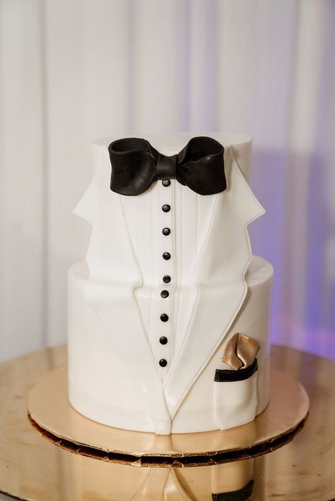 Two-tier white tuxedo grooms cake by The Sugary, LLC | Photo: Audie Jay Photography Classy Grooms Cake, Groom Wedding Cake, Groom Cakes, Groom Cake, Tuxedo Template For Cake, Groom Black Tuxedo White Bowtie, Black Groom White Bride Cake Topper, Tuxedo Cake, Groom Dragging Bride Cake Topper