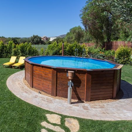 An attractive exterior and the right landscaping can improve the looks of an above ground pool. Otherwise, you can hide it with a wrapround deck. Still, for most people, the typical above ground pool doesn't look as nice as an inground pool. Above Ground Pool Cost, Pool Deck Decorations, Round Above Ground Pool, Piscina Intex, Pool Cost, Pool Deck Plans, Pool Prices, Best Above Ground Pool, Above Ground Pools