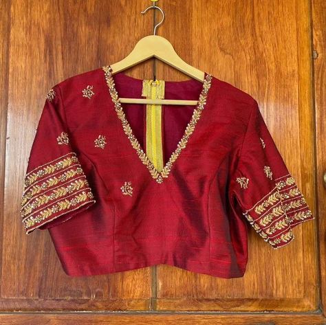 "Stunning Red Maggam Work Blouse at SM Designs! 🔥 Make a bold statement with our Red Maggam Work Blouse, designed for those who love elegance and tradition. Crafted from high-quality Half Pattu/Raw Silk fabric, this blouse features exquisite maggam embroidery, perfect for bridal wear, festive events, and celebrations. Elevate your ethnic wardrobe with this luxurious design, available in customizable colors and sizes. 🌸 Fabric: Half Pattu / Raw Silk 🌸 Dispatch: 4 days 🌸 Price: ₹ for 2400 uns... Maroon Color Maggam Work Blouse Designs, Maroon Work Blouse, Contrast Blouse Designs Latest, High Neck Work Blouses, Burgundy Saree With Contrast Blouse, V Neck Aari Work Blouse, Maroon Maggam Work Blouse, V Neck Maggam Work Blouses, Blouse Zardosi Work Design