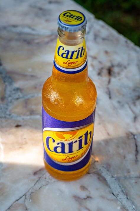 Rum is most certainly more our thing here at Uncommon Caribbean, but we also take great pride in our home region's many varied beers. We've actually published reviews on 48 different Caribbean beers over our 11-year history! Of course, any conversation on Caribbean beer must always start with the brew most synonymous with the region, Carib Beer. Learn why Carib is the Caribbean's undisputed "King of Beers," and let us know if it's your favorite Caribbean beer. Caribbean Bbq, Carib Beer, Drink Ads, Indian People, Character And Setting, Product Labels, Pepper Sauce, Vision Boards, The Caribbean