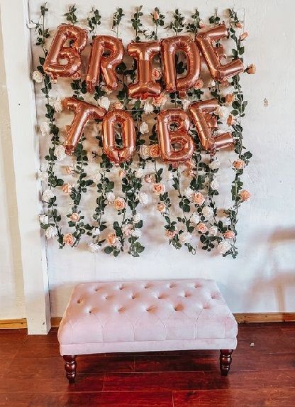 20 Simple Bride To Be Party Decoration Ideas At Home 2024 Photo Wall Bridal Shower Ideas, Hens Party Photo Backdrop, Diy Bridal Shower Photo Backdrop, Bridal Shower Decorations Backdrop, Floral Bridal Shower Photo Backdrop, Hen Party Photo Wall, Simple Floral Bridal Shower Decor, Photo Booth Bridal Shower Ideas, Bridal Shower Tea Party Backdrop