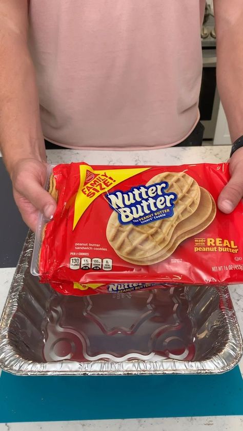 Nutter Butter Pie | This creative Nutter Butter dessert is sure to be a hit at your next family shindig! | By Derek's Creations | Alright, we got some Nutter Butters. Gonna pour probably about half of this container. We'll see. The point of this is just to line the pan with Nutter Butters. I love these things. My mouth is already watering. Let me know what you guys' favorite like cookie treat is out of like Oreos and you think that Nutter Butter's are the best cookie treat. Uh I mean I really li Nutter Butter Lasagna, Nutter Butter Lasagna Desserts, Nutter Butter Recipes, Nutter Butter Pie, Nutter Butter Dessert, Microwave Dessert, Box Cakes, Diy Dessert, Book Video