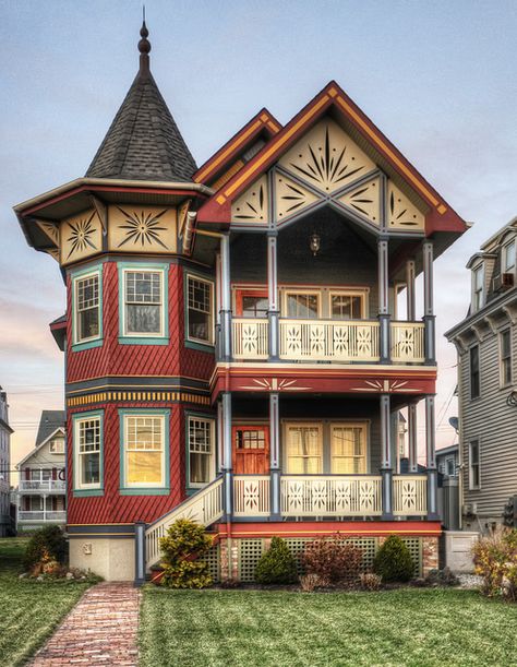 A real fun paint job in Ocean Grove, NJ, photo by LennyNJ, via flickr.  The star shapes on the porch railings and painted in the eaves and the accented porch posts and bands around the house, even the unexpected aqua window frames, very nice! Victorian House Colors, Victorian Style Homes, Tall Buildings, Real Estat, Victorian Mansions, Casas Coloniales, Painted Ladies, Victorian Architecture, Victorian House