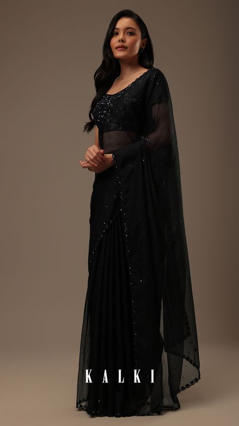 "Introducing our stunning black organza fabricated saree, a testament to refined beauty and exquisite craftsmanship. 
This saree's border is embellished with intricate sequins and cutdana detailing. 
EVENT - Party wear and festive occasions.
The saree comes with a matching unstitched blouse." Black Organza Saree, Pleated Saree, Yumna Zaidi, Kalki Fashion, Dress Book, Saree Designs Party Wear, Net Saree, Black Saree, Embroidery Saree