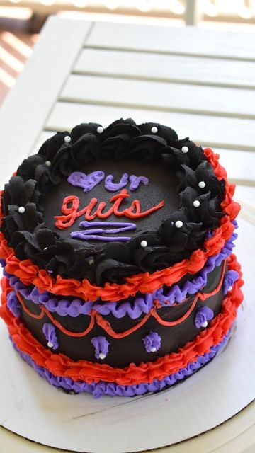 mack on Instagram: "happy guts day! olivia rodrigo ily I will be in the trenches trying to get tour tickets❤️‍🩹🖤✨💜 (also lambeth cake girlies my hand is cramped, my piping is uneven, & if this is your main style I respect you sm) #GUTSalbum #guts #oliviarodrigo #cake #cakedecorating #lambethcake" Guts Birthday Party, Guts Cake Olivia Rodrigo, Olivia Rodrigo Cakes Ideas, Olivia Rodrigo Birthday Cake, Olivia Rodrigo Cake, 15th Birthday Cakes, Make Birthday Cake, 13 Birthday Cake, Cute Birthday Ideas