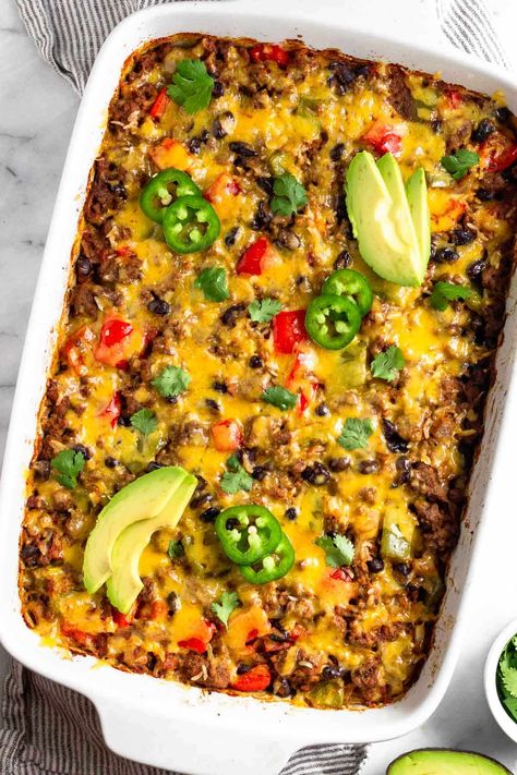 Comfort food doesn’t get much better than this beef burrito casserole. Seasoned ground beef, veggies, rice, and beans are baked together and then topped with melty cheese for a delicious healthy casserole recipe. High protein, gluten-free, and great for meal prep. Deconstructed Burrito Casserole, High Protein Ground Beef Casserole, Beef And Bean Taco Casserole, Keto Burrito Casserole, Burrito Casserole Recipe Beef, Healthy Baked Casserole Dinners, Easy Chicken Burrito Casserole, Mexican Casserole With Beef Healthy, Casserole Recipes High Protein