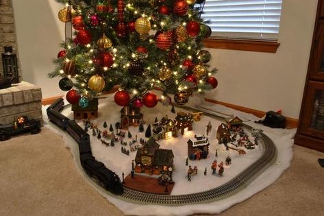 Christmas Village Under The Tree, Train Under Christmas Tree Ideas, Christmas Village Under Tree, Train Track Around Christmas Tree, Christmas Train Display Under Tree, Christmas Tree With Train In It, Christmas Tree Train Platform, Train Under Christmas Tree, Train And Village Under Christmas Tree