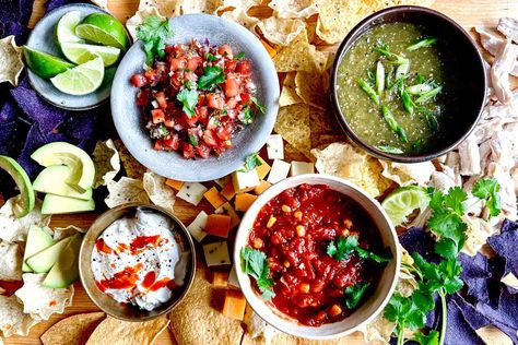 A fresh, colorful platter for sharing, a salsa board combines several salsas with tortilla chips and other foods such as pickled peppers, avocado, and cheese. Here's how to make a salsa board, including how to choose the right salsas. Salsa Board, Charturie Board, Martha Stewart Cooking School, Toasted Pumpkin Seeds, Toast Toppings, Sweet Heat, Breakfast Toast, Fresh Salsa, Chips And Salsa