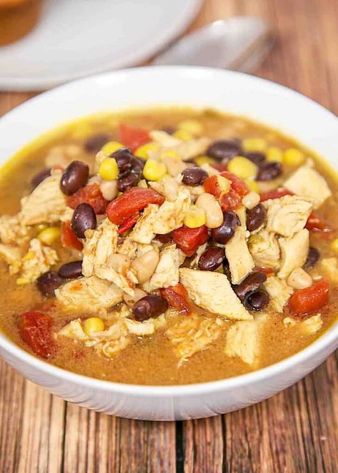 Chicken Taco Soup made in the slow cooker/crock-pot - tastes like the Chicken Tortilla Soup from Chick-fil-a - SO good! Chicken, taco seasoning, cream of chicken soup, chicken broth, navy beans, black beans, Rotel diced tomatoes, and corn. Simply dump everything in the crockpot and cook. Freezes well too! Serve with a salad and bread. This is on repeat at our house. YUM! #crockpot #slowcooker #chicken #soup #chili #mexicanfood Slow Cooker Chicken Taco Soup, Chicken Taco Soup Recipe, Slow Cooker Chicken Tacos, Tortilla Soup Recipe, Taco Soup Recipe, Chicken Taco Soup, Chicken Taco, Plain Chicken, Slow Cooker Dinner