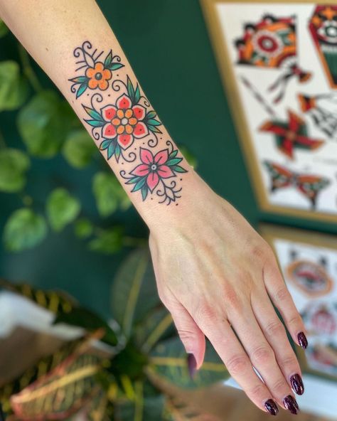 Traditional Flower Wrist Tattoo, Lower Arm Wrist Tattoos For Women, Old Style Flower Tattoo, Americana Flower Tattoo, Narrow Traditional Tattoo, American Traditional Birth Flowers, Traditional Flower Tattoo Color, Forearm Wrist Tattoo Women, Traditional Floral Sleeve