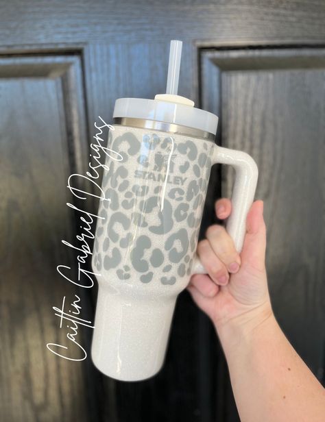 Leopard Print Tumbler  If you are wanting the cup in the LISTING PHOTO you MUST select the option "Stanley 40 oz" from the drop-down. I offer multiple cup styles with this design. If you have any questions feel free to reach out!  Unless otherwise requested Stanley and Simple Modern tumblers will be made using a cream or white base cup. If you want something besides the white and gray please add it to the personalization box! I have a TON of glitter options as well as vinyl, so this is completely customizable.  The tumbler is sealed with epoxy to give a glass-like finish.  CARE INSTRUCTIONS: -HAND WASH ONLY -DO NOT MICROWAVE -DO NOT SOAK -NOT DISHWASHER SAFE -AVOID EXTREME TEMPERATURES -AVOID HARSH CHEMICALS  Due to the personalized nature of this product, returns/exchanges are not accepte Stanley Cup Designs, Leopard Print Tumbler, Starbucks Cup Art, Tumblr Cup, Trendy Water Bottles, Leopard Tumbler, Stanley Cups, Cute Coffee Cups, Yeti Cup