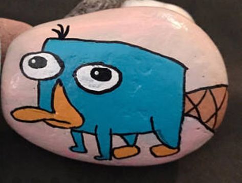 Perry platypus painted rock Perry The Platypus Painting, Platypus Painting, Perry Platypus, Christmas Rocks, Footprint Craft, Perry The Platypus, Christmas Rock, Platypus, Diy Activities