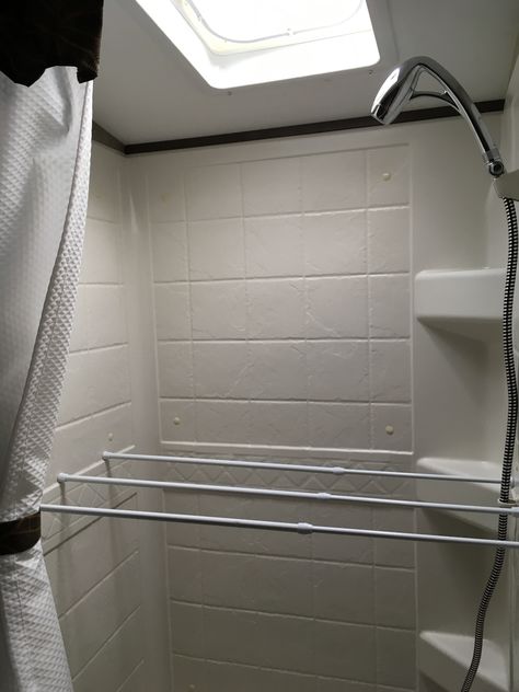 RV towel bar hack - tension rods in the shower. Use as a drying rack when parked, and use the rods to secure items in cupboards when travelling. Camper Drying Rack, Rv Towel Drying Rack, Rv Drying Rack, Towel Drying Rack Bathroom, How To Hang Towels, Camper Revamp, Tension Rod Curtains, Towel Drying Rack, Trailer Camping