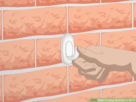 3 Simple Ways to Hang Garland on Brick - wikiHow How To Hang Something On Brick, How To Hang Garland On Brick House, Hanging On Brick Wall, Hanging Garland Around Front Door, Hanging Garland On Brick, How To Attach Garland To Brick, How To Hang Things On Brick, How To Hang On Brick Wall, How To Hang Garland On Brick