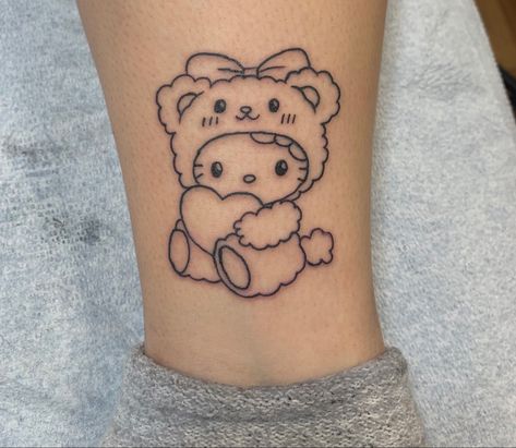 Hello Kitty Best Friend Tattoo, Hello Kitty Lower Back Tattoo, Hello Kitty And Friends Tattoo Ideas, Teddy Bear Heart Tattoo, Hello Kitty Ankle Tattoo, Bear Holding Flowers Tattoo, Simple Hello Kitty Tattoo, Hello Kitty Arm Tattoo, Hello Kitty Chest Tattoo