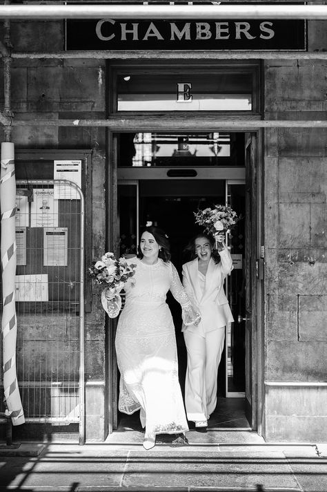 Brides celebrate as they leave wedding ceremony in black and white image Lesbian Court Wedding, Elopement Pics, Manchester Wedding, Boho Lace Wedding Dress, Courthouse Wedding Photos, Registry Office Wedding, Queer Weddings, Edinburgh Wedding, Nyc Elopement