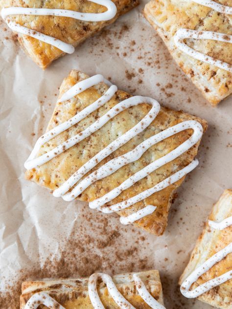 Looking down on a cinnamon roll pop-tart with vanilla icing and cinnamon sprinkled on top Pie Crust Cinnamon Rolls, Homemade Cinnamon Roll, Cinnamon Sugar Recipes, Poptart Recipe, Puff Pastry Filling, Sugar Recipes, Tart Filling, Vanilla Icing, Vanilla Glaze