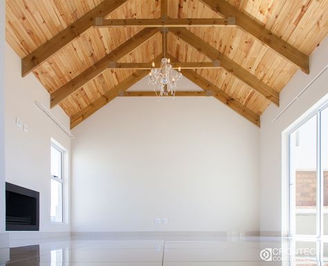 A high ceiling with exposed trusses and knotty pine with a center chandelier for that touch of elegance. Pine Roof Ceiling, Corner Table Designs, Knotty Pine Ceiling, Pine Ceiling, Exposed Trusses, Roof Ceiling, Cabin Kitchen, Knotty Pine, Still Life Flowers