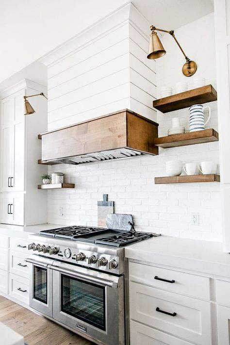 White modern farmhouse kitchen with shiplap range hood, open wood shelving, and swing arm sconces - Sita Montgomery Interiors Dapur Rustic, White Modern Farmhouse, Interior Design Minimalist, House Farm, Kabinet Dapur, Farmhouse Kitchen Cabinets, Farmhouse Kitchen Design, Kitchen Hoods, Farmhouse Interior