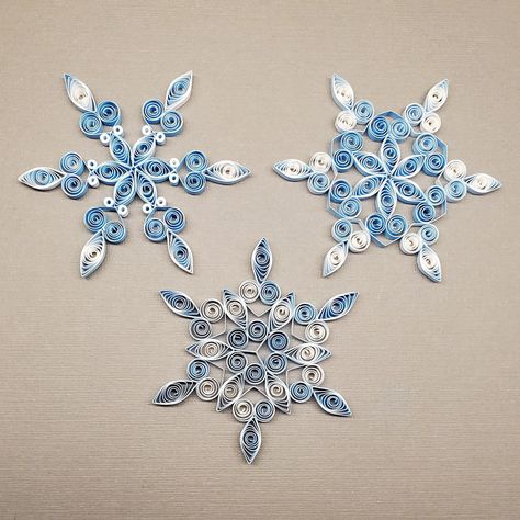 "Paper quilled snowflake ornaments for winter decorations, Christmas trees, first (paper) anniversary gift, gift accents, gift toppers. This listing has three blue and white paper snowflakes in 3 styles; approximate size:  2 7/8\" diameter and 1/8\" thick; These snowflakes are small and fragile. Take care handling and storing them. Tweezers are useful in picking them up. Ornament hooks are included. For other color and style combinations check out my custom order snowflake listing." Christmas Quilling, Winter Decorations, Paper Gifts Anniversary, Ornament Hooks, Gift Toppers, Paper Anniversary, Paper Snowflakes, Quilling Designs, Quilling Art