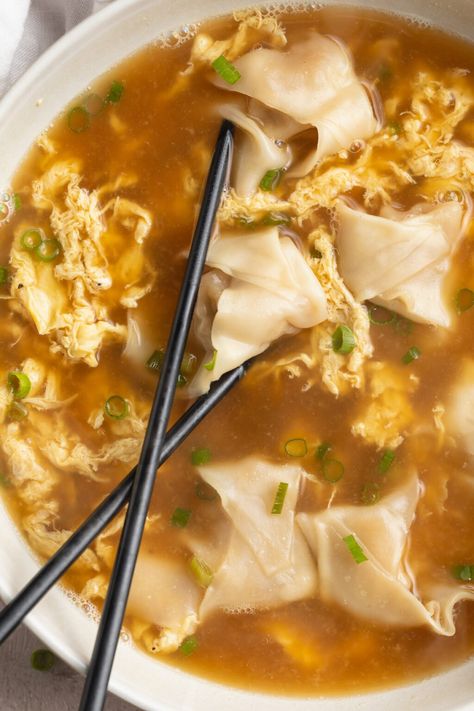 Savory and satisfying wonton egg drop soup combines two popular Chinese soups into one delicious dish. With mostly-homemade wontons, a flavorful broth, and ribbons of eggs, this easy-to-make soup is every bit as filling as it is appealing. A scrumptious main course, or the perfect appetizer for a night of takeout-inspired favorites. Homemade Wontons, Greek Chicken Meatballs, Homemade Egg Drop Soup, Chinese Soups, Peach Pork Chops, Best Risotto, 40 Aprons, Best Paleo Recipes, Egg Drop Soup