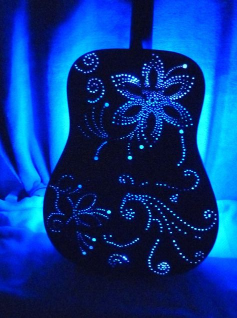 I drilled holes on the back and sides of the acoustic guitar in a whimsical design to  emit ambient lighting.  LED RGB Light Strip w/remote included Upcycle Guitar Ideas, Guitar Art Diy, Guitar Lamp, Guitar Decorations, Acoustic Guitar Art, Guitar Light, Music Furniture, Guitar Crafts, Guitar Display