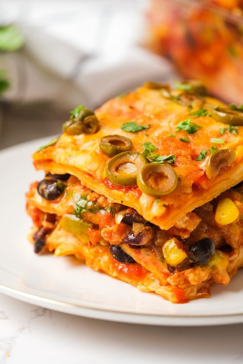 Loaded with meaty goodness, beans, corn, olives and more, Mexican Tortilla Lasagna is a tasty twist on the Italian classic! Mexican Lasagna With Tortillas, Tortilla Lasagna, Mexican Tortilla, Most Pinned Recipes, Hispanic Recipes, Mexican Lasagna, Night Recipes, School Recipes, Mexican Casserole