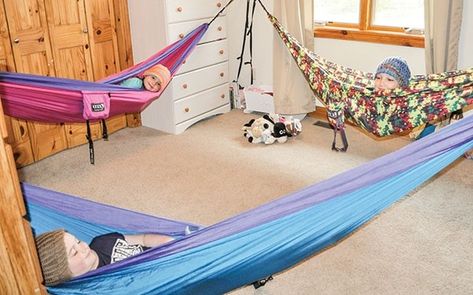 The Mason kids started sleeping in hammocks last summer, and now prefer their hammocks to beds. Sisters Lily, 7, (foreground), Faith, 6, (left) and Danica, 10, (right) share a room. Instead of making beds in the morning, they simply fold up their hammocks, leaving the bedroom open for the kids to play. Lily made hats so the girls’ hair doesn’t get staticky. Hammock Room, Active Playroom, Hammock In Bedroom, Sleeping Hammock, Kids Hammock, Hammock Stands, Hammock Bed, Bonus Rooms, Bunk Room