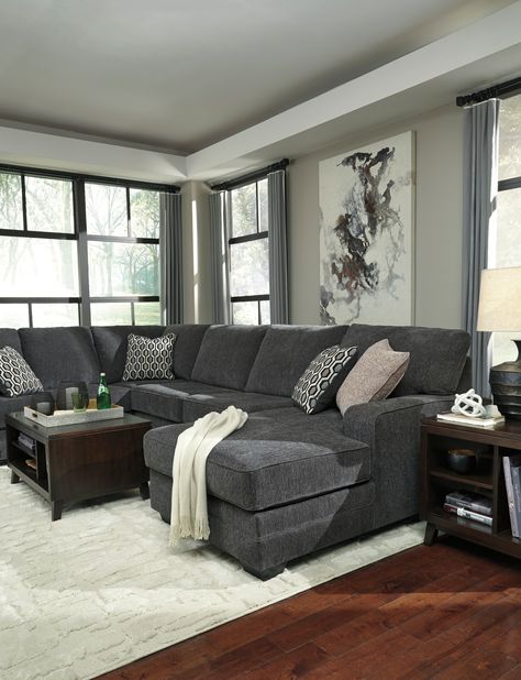 INFORMATION Talk about easy street. This effortlessly chic sectional puts you at the intersection of cool and comfortable. Ultra-deep seats are custom made for afternoon naps and movie night marathons. So plush to the touch, the sectional’s slate gray upholstery is beautifully on trend. Item Name: Tracling 3-Piece Sectional with Chaise by Ashley SKU: 72600S2 FEATURES Corner-blocked frame Attached back and loose seat cushions High-resiliency foam cushions wrapped in thick poly fiber 5 decorative Gray Sectional Living Room, Dark Grey Couch Living Room, Dark Grey Sectional, Dark Grey Couches, Dark Gray Sofa, Grey Sofa Living Room, Grey Couch Living Room, Sectional With Chaise, Corner Chaise