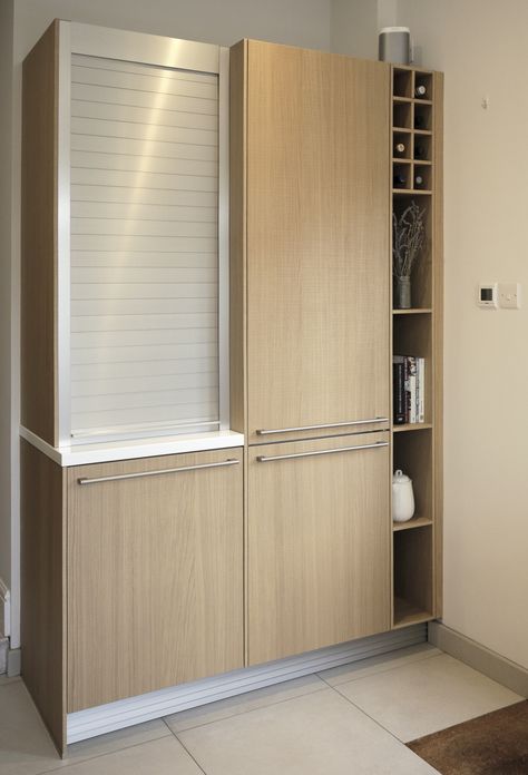 Natural saw-cut oak tall cabinet with stainless steel roller-shutter door and Corian worktop.   #kitchen #cooking #storage #rollershutter #stainlesssteel #oak #veneer #tallunit #cabinet #schuller #next125 Kitchen Roller Shutter Cabinet, Roller Shutter In Kitchen, Corian Worktop, Kitchen Shutters, Minimalist Entryway, Stainless Steel Kitchen Cabinets, Top Kitchen Cabinets, Glass Kitchen Cabinets, Modern Facade