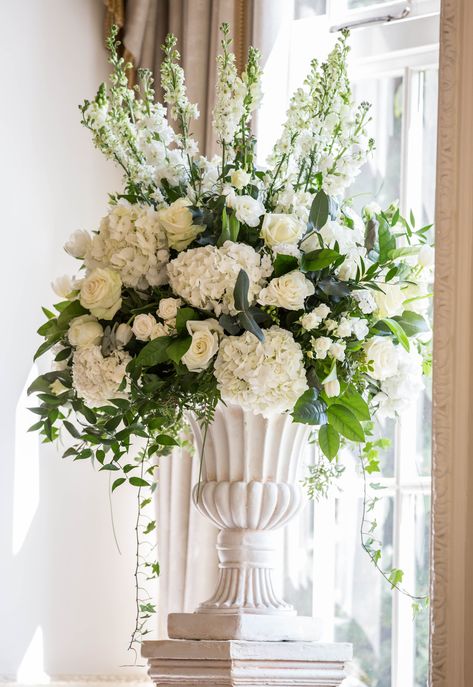 Fabulous white and green wedding flowers in a white urn on a plinth in the Drawing Room at Yorkshire venue Goldsborough Hall. Altar Flower Arrangements, Altar Florals, Bridal Bouquet Handle, White And Green Wedding Flowers, Stage Decoration Photos, Classic Wedding Flowers, Wedding Columns, White Urn, White And Green Wedding