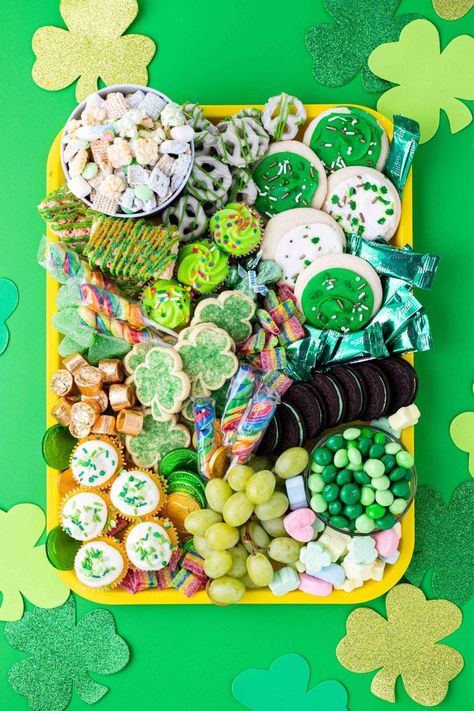 Looking for a fun and festive way to celebrate St. Patrick's Day? Why not try creating a St.Patrick's Day charcuterie board? St Patrick's Day Charcuterie Board, Green Popcorn, White Chocolate Covered Pretzels, Shamrock Cookies, Chicken A La King, Lucky Charms Marshmallows, Fruit Chews, Mint Oreo, Fresh Meals