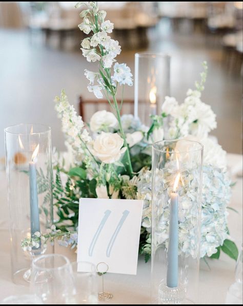 Light Blue Flower Bouquet Wedding, Dusty Blue Wedding Table Centerpieces, Candle Wedding Centerpieces Round Tables, Floral Centerpieces Round Table, Table Centerpieces Wedding Blue, Simple Wedding Table Scape, Delphinium Centerpiece Wedding, Blue Candlesticks Wedding, Light Blue Wedding Flowers Centerpiece