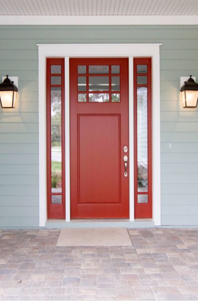 31 Houses with Red Front Entry Door Ideas | Sebring Design Build Red Front Doors With Glass Panels, Burnt Red Front Door, Dark Red Front Door Paint Color, Houses With Red Front Doors, Red Front Door Paint Color, Red Front Door Decor, Red Front Door Ideas, Red Door Yellow Door, Red Front Doors