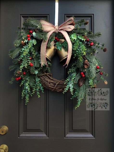 "Who doesn't love the sound of that jingle around the holidays! This wreath is adorned with rustic gold metal bells (that do jingle), red berries, pine branches, eucalyptus, pine cones and a bordered burlap bow. The finished wreath measures around 24\"-25\" from tip to tip. PLEASE NOTE: Wreaths are made to order and each one will have its unique characteristics. In most cases, the end product will most likely look just like the picture, however varying elements of the wreath may be used based on Christmas Jingle Bells Decorations, Fresh Wreaths Christmas, Christmas Wreaths For Front Door Rustic, Unique Christmas Wreaths, Evergreen Wreaths, Elegant Wreaths, Christmas Tree Decorations Ribbon, Home Decor Winter, Red Christmas Wreath