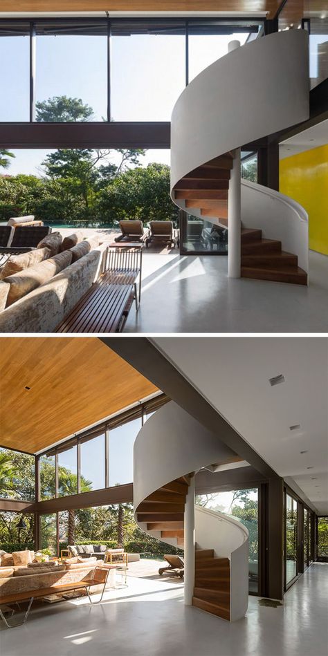 This white and wood modern spiral staircase is fully exposed in the interior and provides access to the second floor of the house. Spiral Stairs Design, Wood Stair Treads, Casa Loft, Exterior Stairs, Stairway Design, Stairs Design Modern, Stairs Architecture, Home Stairs Design, Wooden Staircases