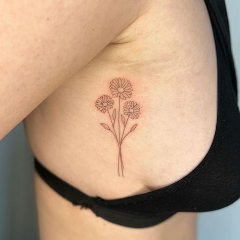 Pure and innocent — that's how people imagine chamomile, and this is one of its main meanings. But there are others. What are they? Read our article. Bonus: 60 cool daisy tattoo ideas you'll love. Daisy Tattoo Ideas, Daisy Tattoos, Daisy Tattoo Designs, Family Tattoo Designs, Bouquet Tattoo, Halloween Memes, Daisy Tattoo, Sternum Tattoo, Memorial Tattoos