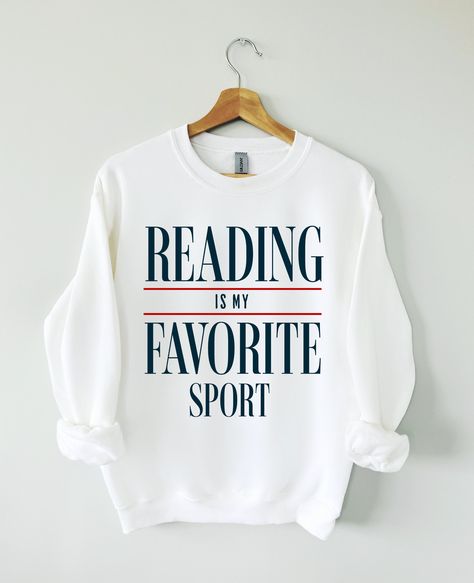 Hey Book lover, show off your love for Reading Books with our Reading is my favorite sport sweatshirt. The perfect gift for Readers, Librarians, Bookworms, Book Addicts, Book Nerds and Book Lovers.  All designs are available on tshirts/sweatshirts/hoodies. Send me a message if you can't find the product you need! MATERIAL ✨ Sweatshirt sizes are Unisex, please refer to sizing chart in listing photos ✨ 50% cotton, 50% polyester �✨ Medium fabric weight ✨ DTG Printed CARE ✨ Machine wash: warm (max 40 Book Nerd Sweatshirt, Book Lover Tshirt Design, Book Lover Shirt Ideas, Love Reading Quotes, Book Sweatshirts, Book Sweater, Reading Sweatshirt, Book Nerd Shirts, Book Clothes