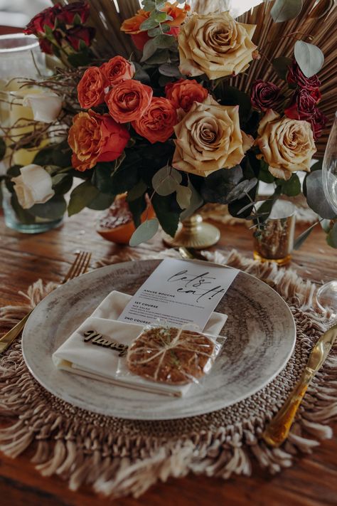 Macrame charger, gold cutlery, ivory napkin, cookie, printed menu "lets eat", boho. Orange, ivory, peach, blush.roses, mini roses, dry leaves and pampas #macramewedding #macrame #chargerwedding #menuinspo #menuweddinginspo #weddingbohocenterpiece Macrame Charger, Boho Centerpiece, Lets Eat, Boho Orange, Dry Leaves, Gold Cutlery, Macrame Wedding, Peach Blush, Mini Roses