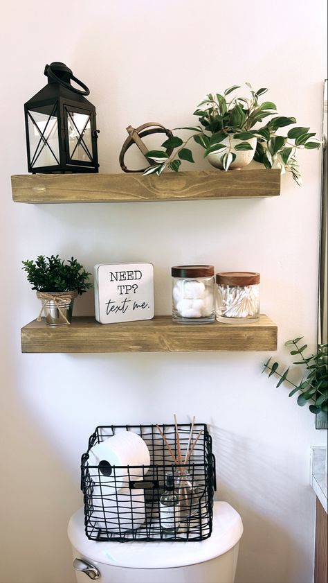 Black Shelf Decor Bathroom, Powder Bathroom Shelf Decor, Hobby Lobby Floating Shelves, Bathroom Greenery Decor, Bathroom Shelf Decor Over Toilet Modern, Floating Shelf Bathroom Decor, Black Wire Basket Decor, Wire Basket Decor Bathroom, Bathroom Shelving Decor