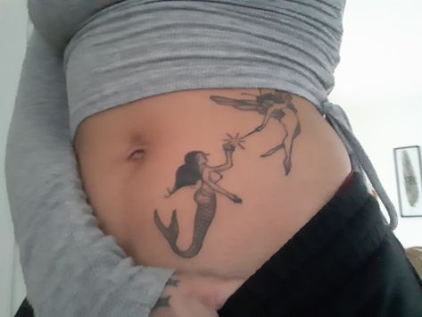 Fairy with butterfly wings and mermaid tattoo in black Ink on lower abdomen. Fairy Stomach Tattoo, Fairy Sternum Tattoo, Mermaid And Fairy Tattoo, Fairy And Mermaid Tattoo, Fairy And Mermaid, Bday Tattoo, Side Stomach Tattoos, Tummy Tattoo, Belly Tattoo