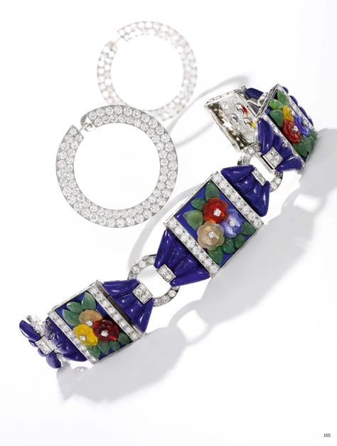 ATTRIBUTED TO PALTSCHO | AN ART DECO LAPIS LAZULI, HARDSTONE, ENAMEL, AND DIAMOND BRACELET, 1930S. Composed of panels applied with blue enamel and flowers in carved chalcedony between sections of fluted lapis lazuli and ring connectors, highlighted throughout with millegrain-set brilliant- and circular-cut diamonds, length approximately 185mm, unsigned. Egyptian Revival Jewelry, Bijoux Art Deco, Haute Jewelry, Vintage Tiara, Tiaras Jewellery, Jewelry Diamonds, Art Nouveau Jewelry, Gold Bracelets, Gemstone Jewellery