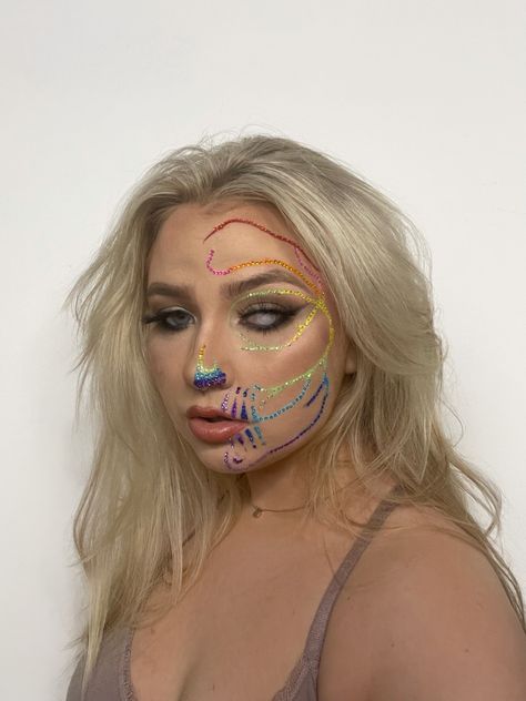 This is a rainbow rhinestone skull makeup look on half of my face. Rainbow Skull Makeup, Halloween Makeup Inspo, Rainbow Skeleton, Skull Halloween Makeup, Rainbow Skull, Rhinestone Skull, Skeleton Makeup, Skeleton Costume, Diy Rainbow