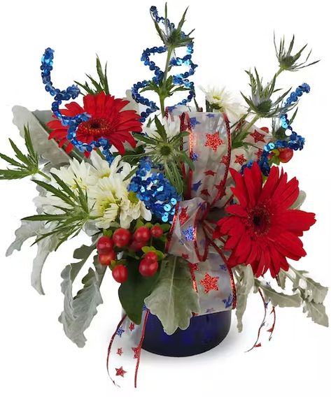 Festive Fireworks | Indianapolis Patriotic Flowers Patriotic Flower Arrangements, Patriotic Flowers, Thistle Design, Blue Delphinium, Patriotic Bows, Gerbera Daisies, Blue Glass Vase, Fireworks Display, Spray Roses