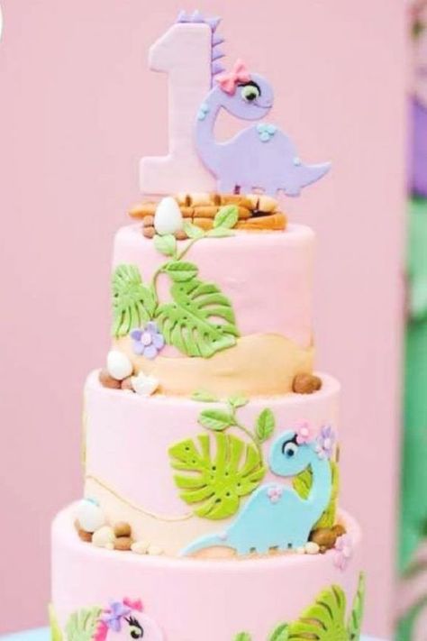 Little girls love dinosaurs as much as boys, so, if you are treating your daughter to a dinosaur-themed party you won't want to miss this amazing pink dino cake! Covered in pink fondant icing, each tier is decorated with delicate leaves, flowers, and cute dinosaurs with bows. See more party ideas and share yours at CatchMyParty.com Dinosaur Cake For Girls Birthday, Girl Dinosaur Cake, Dino Cakes, Dino Birthday Cake, Girl Dinosaur Birthday, Dinosaur Birthday Party Decorations, Dino Cake, Dinosaur Birthday Cakes, Dinosaur Themed Birthday Party