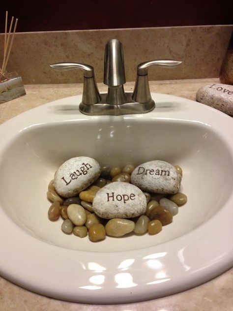 River stones in your bathroom sink #FengShui Rocks In Sink Decorative, Zen Spa Bathroom Ideas, Rocks Decor, Zen Bathroom Ideas, Feng Shui Dicas, Feng Shui Front Door, Feng Shui Bathroom, Zen Bathroom Decor, Zen Bathroom Design